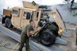 -US_Navy_110423-N-7293M-805_Marine_Lance_Cpl__Luis_Jimenez_uses_a_pressure_washer_to_clean_the_u.jpg